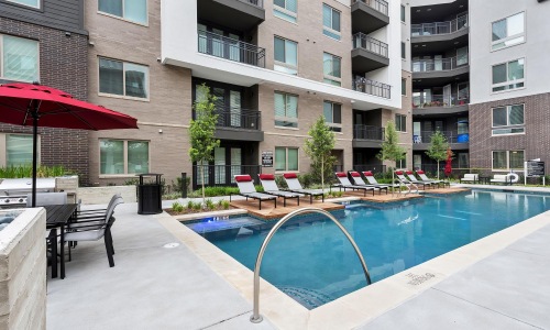 a swimming pool in a courtyard between buildings