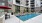 a swimming pool in a courtyard between buildings
