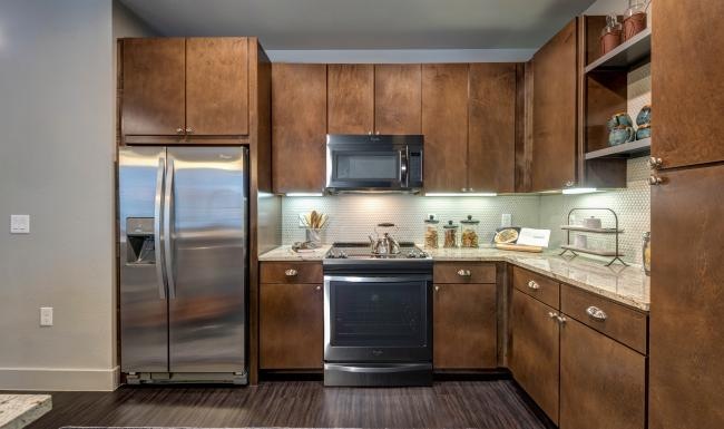 a kitchen with wooden cabinets