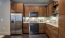 a kitchen with wooden cabinets