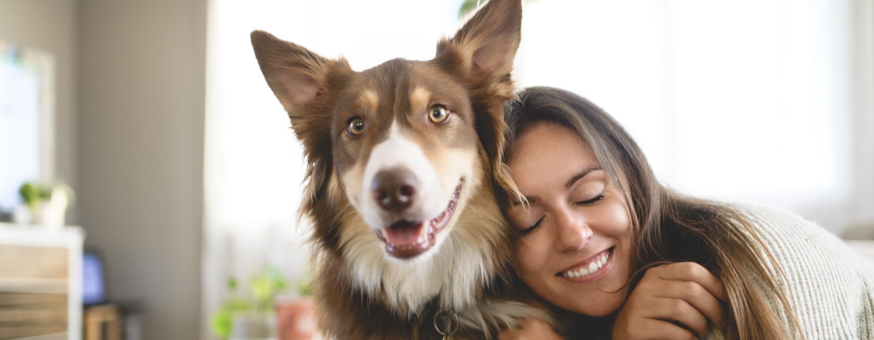 a woman hugging a dog