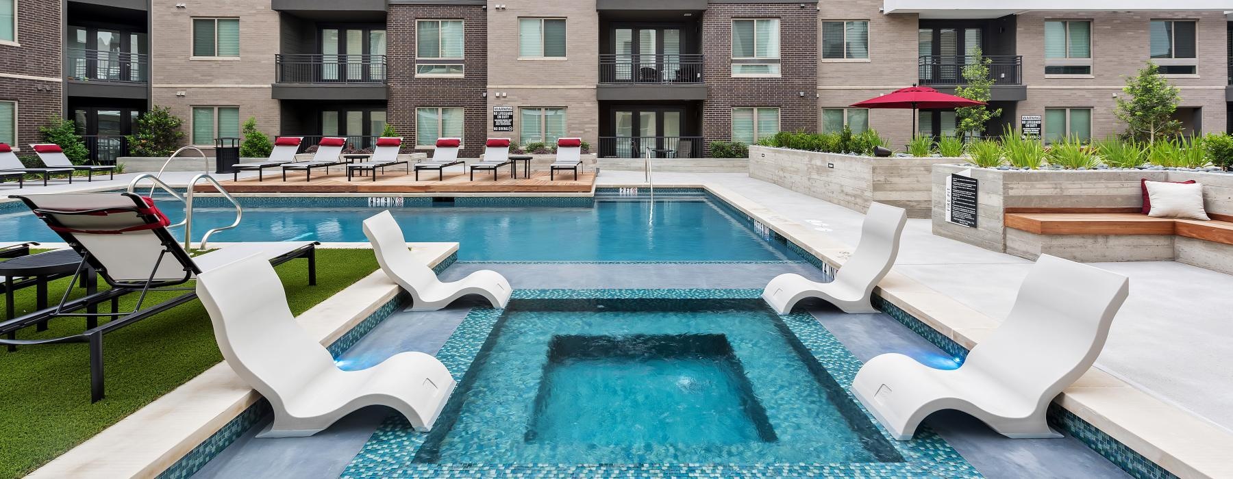 a pool with lounge chairs around it