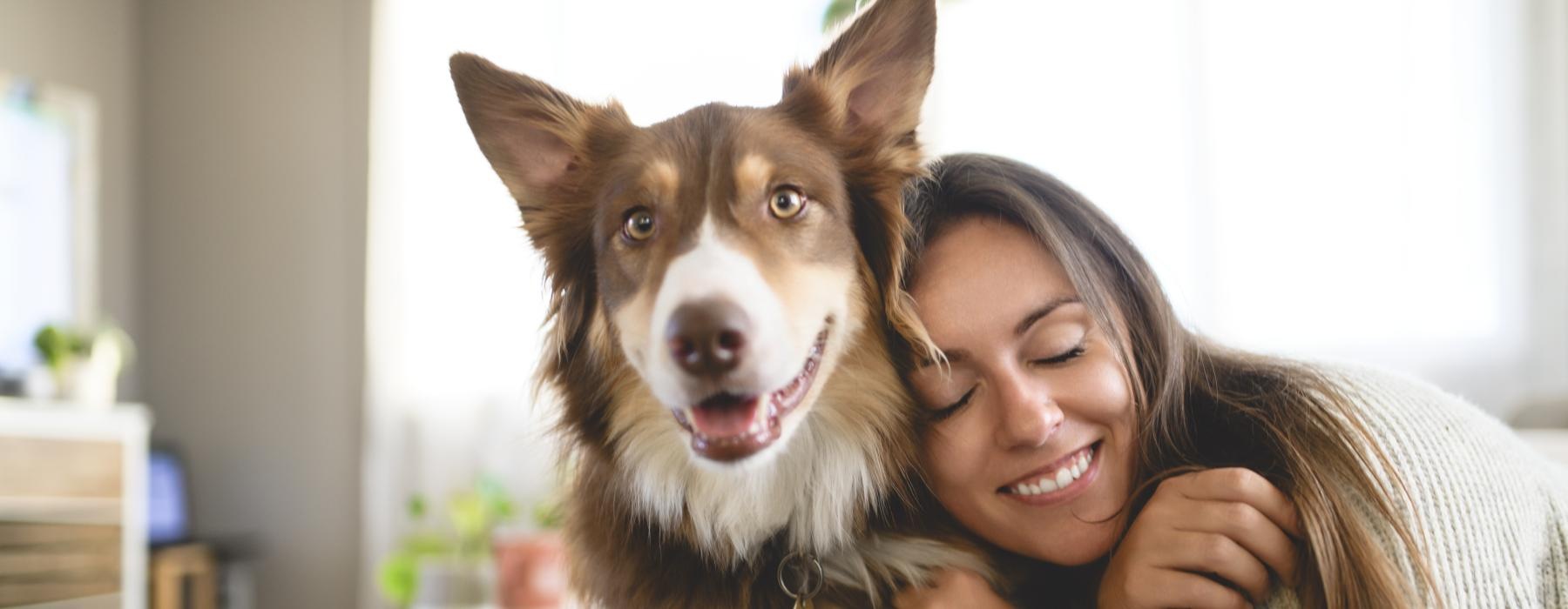 a woman hugging a dog